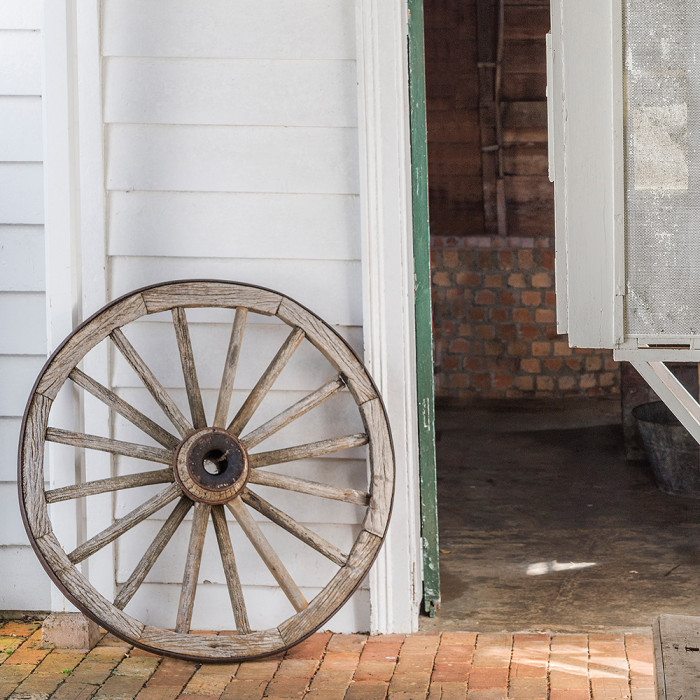 Wagon wheel leaning against the building at Alberton