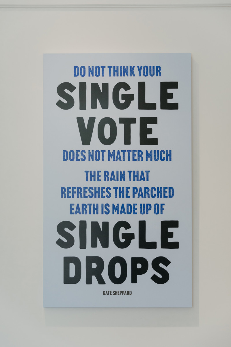 A poster from Kate Sheppard House that says 'Do not think your single vote does not matter much. The rain that refreshes the parched earth is made up of single drops' - Kate Sheppard